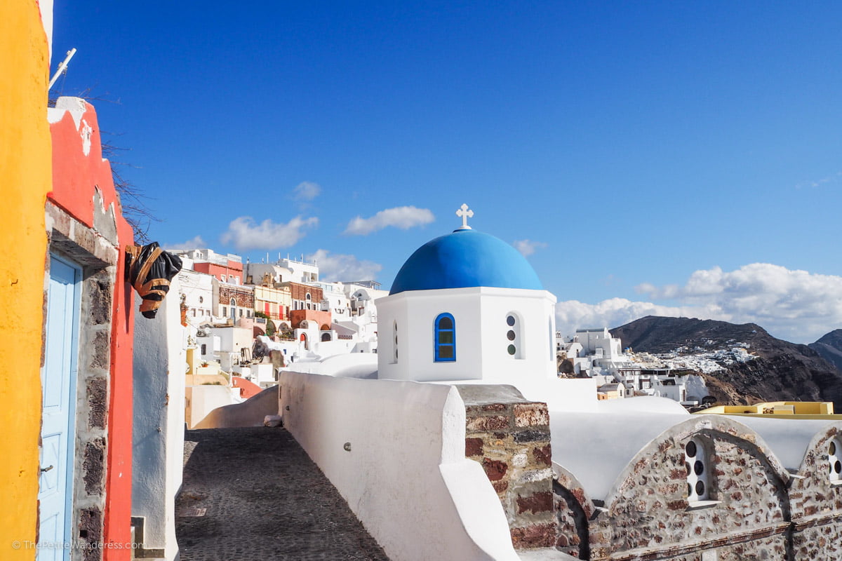 blue domed and white church in Santorini | Santorini in shades of blue & white • The Petite Wanderess